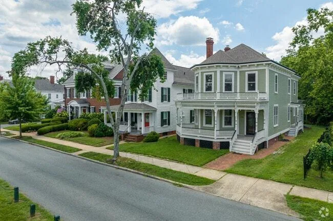 Historic two-story homes on a tree-lined residential street in Fredericksburg, VA